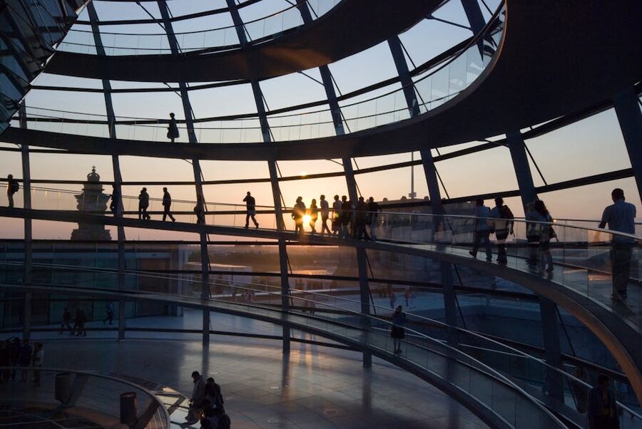 Silhouettes of visitors on the ramp at sunset inside the Reichstag dome