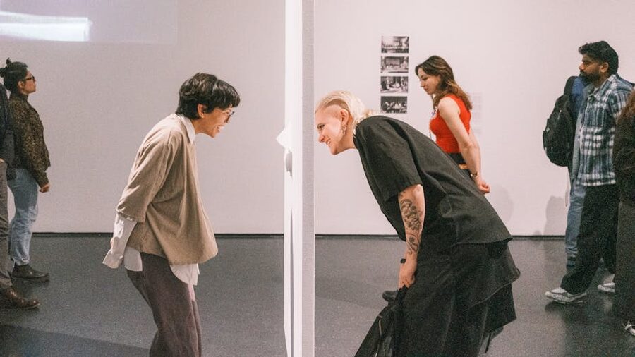 Visitors interacting with art installation at indoor exhibition