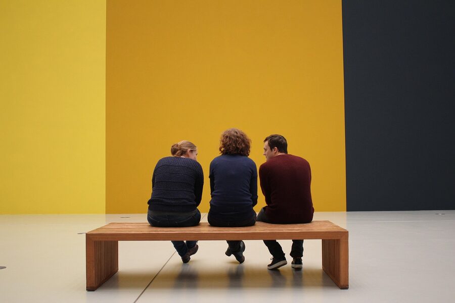 Museum visitors viewing exhibition art on display