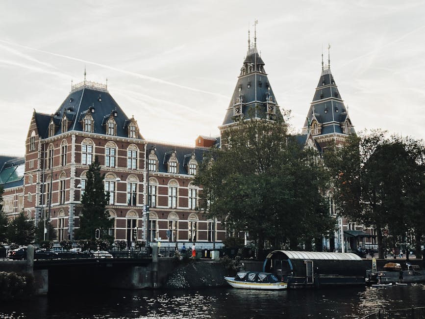 The Rijksmuseum facade seen from across an Amsterdam canal