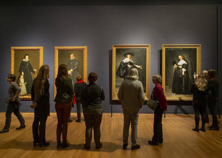 Visitors viewing paintings in a Rijksmuseum gallery