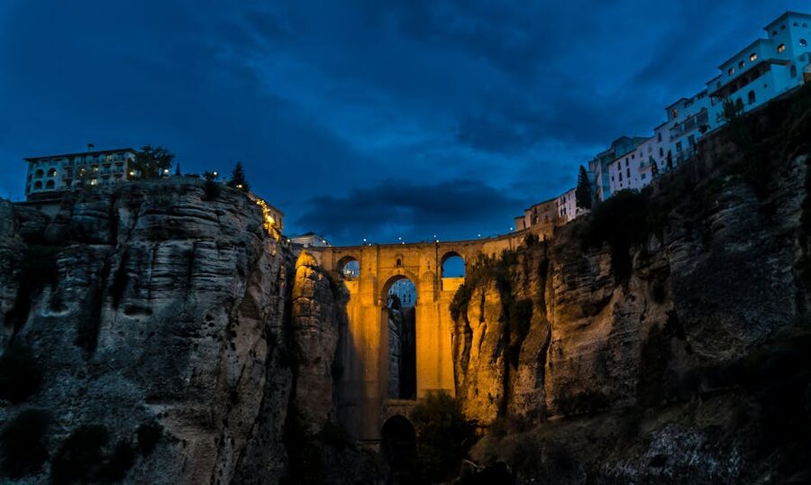 Ronda Puente Nuevo illuminated against blue evening sky