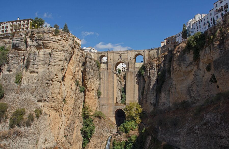 Ronda Puente Nuevo with old castle ruins on cliff edge