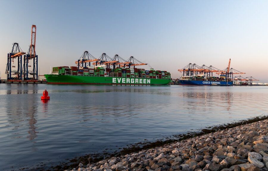 Container ships docked at the Port of Rotterdam at sunrise glowing under a soft sky