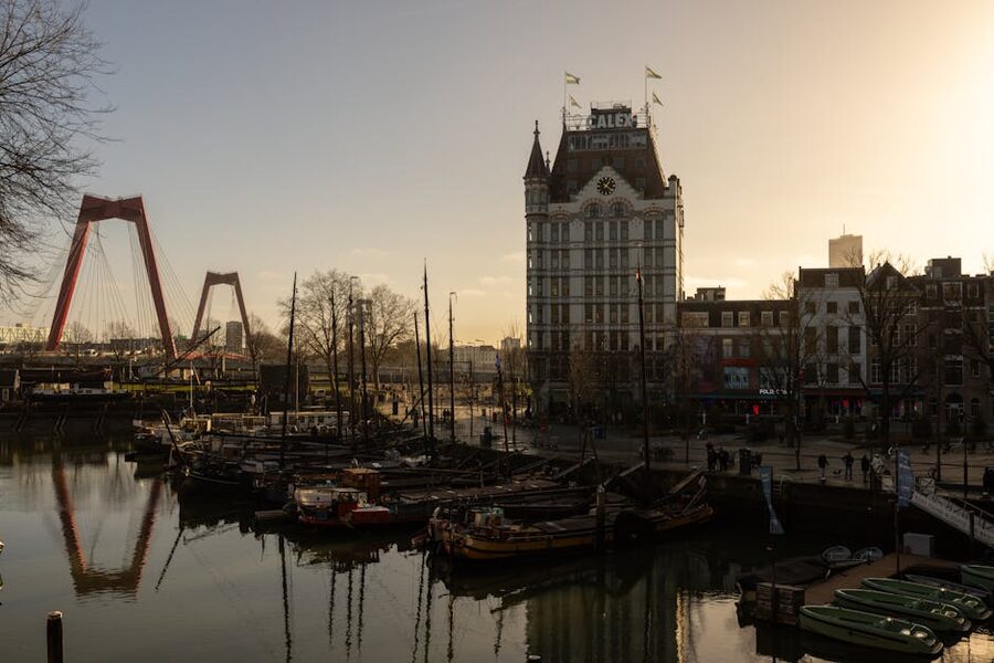 The Willemsbrug bridge and the historic Witte Huis (White House) art nouveau building at sunset in Rotterdam