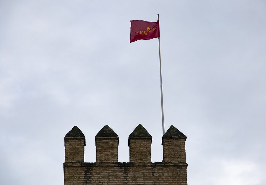 Royal Alcazar Seville flags at the Lion Gate entrance
