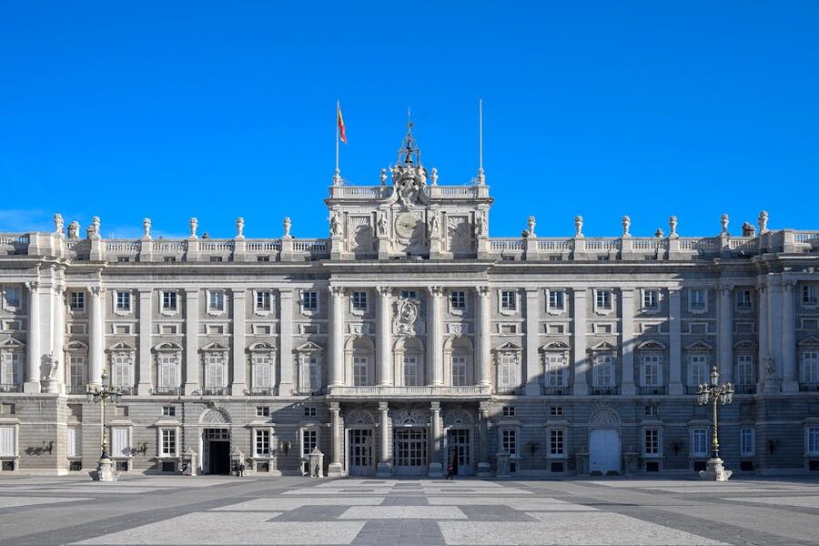 Royal Palace of Madrid neoclassical facade against a clear blue sky