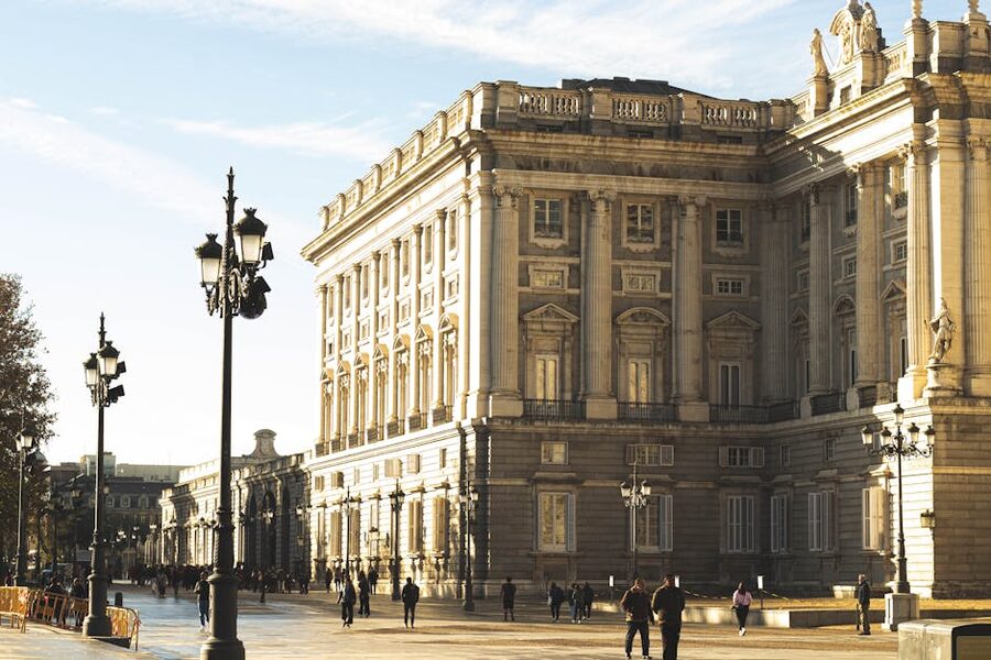 Royal Palace Madrid in golden afternoon light with streetlights