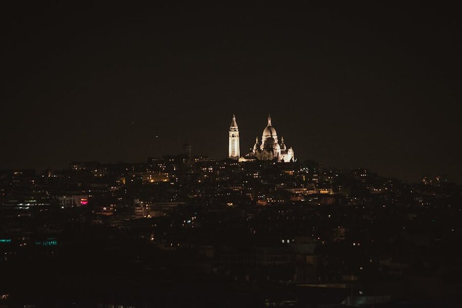 The illuminated Sacre Coeur basilica in Montmartre at night Paris