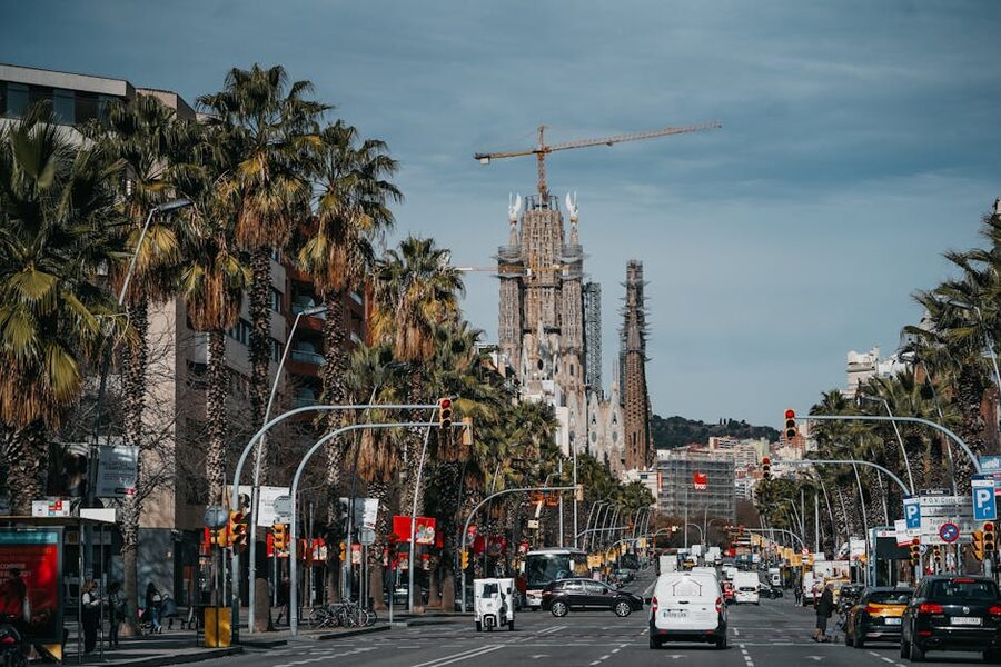 Sagrada Familia seen from a Barcelona street with construction visible