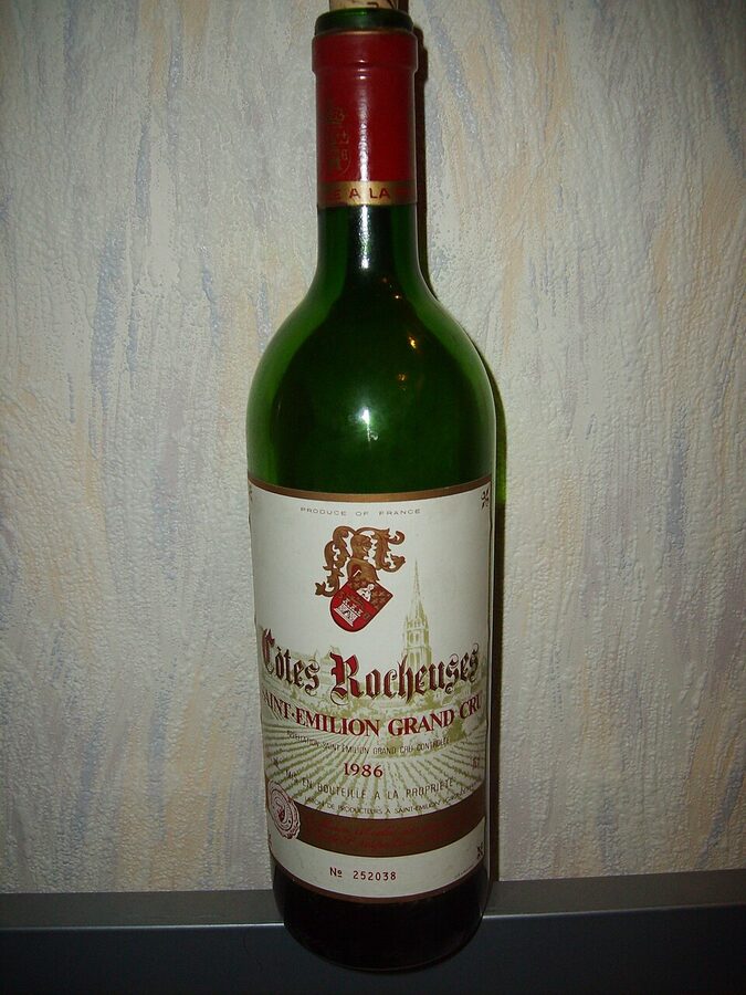 A bottle of Saint-Émilion wine on a wooden surface