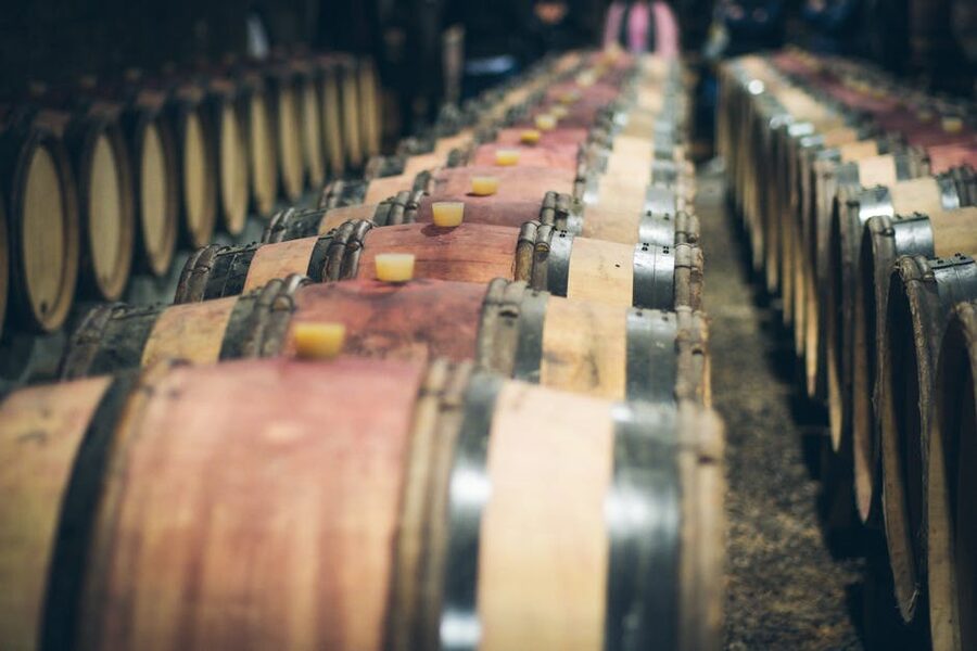 Wine barrels aging in a dimly lit Saint-Émilion cellar