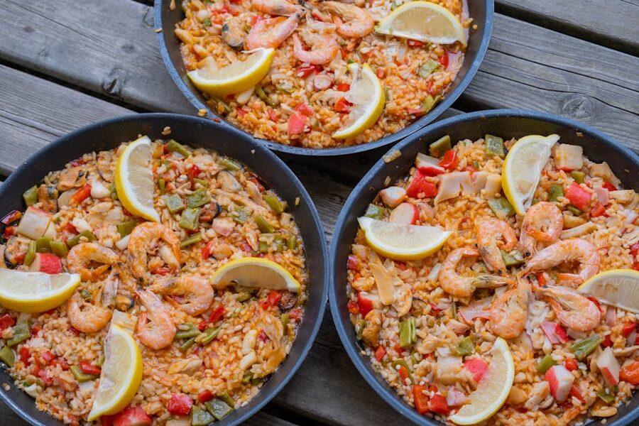 Three pans of seafood paella