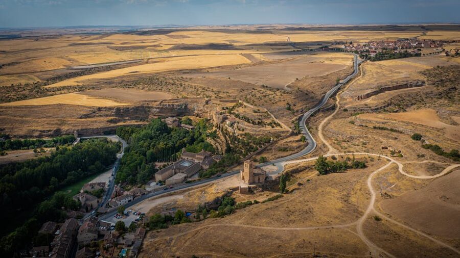 Aerial view of Segovia with Alcazar castle and rolling fields
