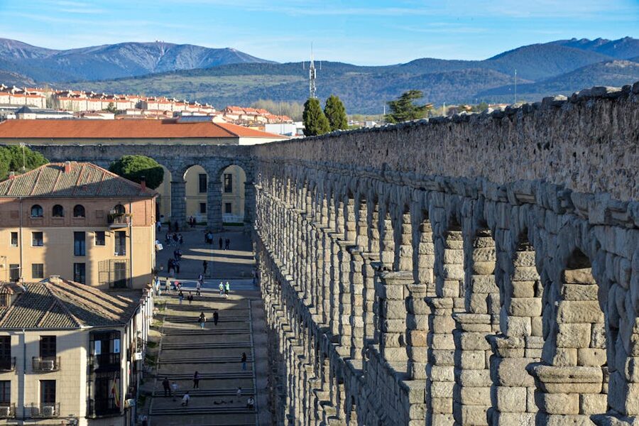 Roman aqueduct of Segovia with mountains in background