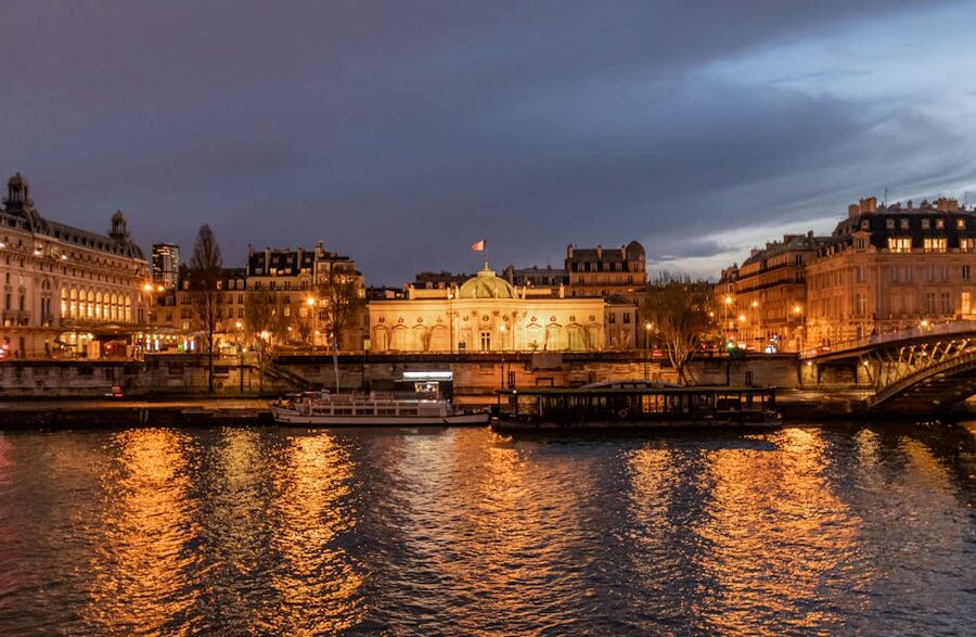 Illuminated Parisian bridges and landmarks reflecting in the Seine at night