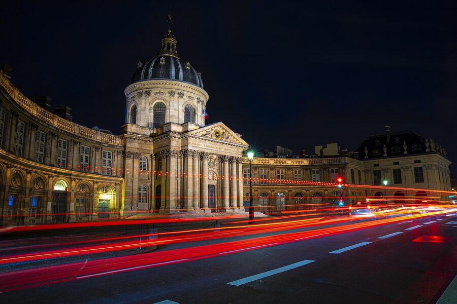 Paris at night with illuminated monuments along the Seine river