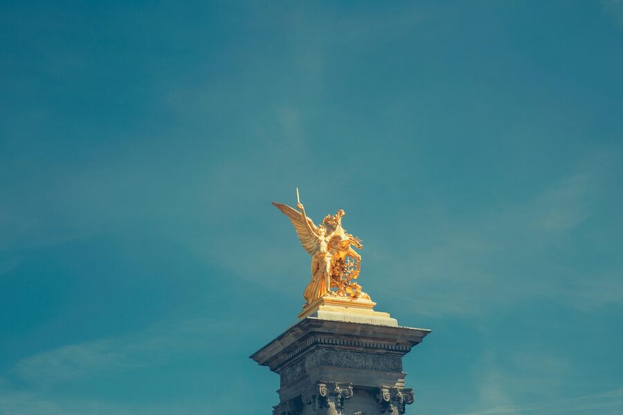 Pont Alexandre III stone pillar with bronze statue of a knight on horseback