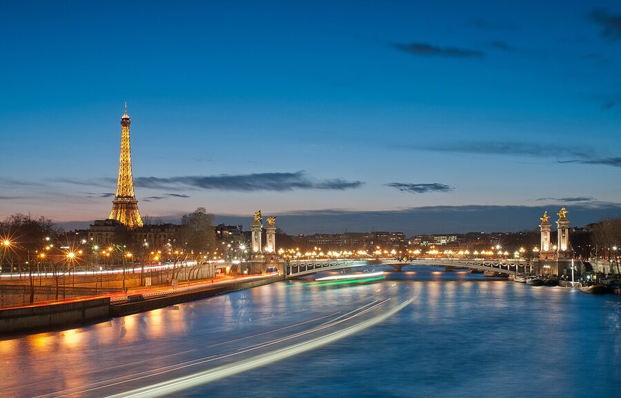 Eiffel Tower and Pont Alexandre III illuminated at night in Paris