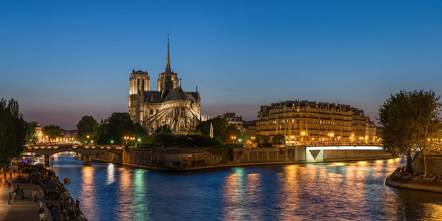 Notre-Dame de Paris and the Ile de la Cite at dusk with reflections on the Seine