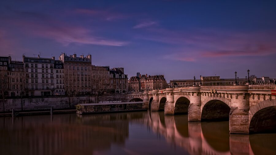 Pont Neuf at evening with reflections on the Seine and Paris lights in Paris