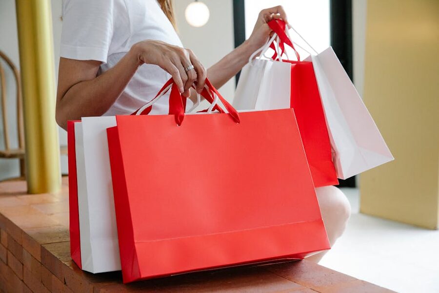 Tired shopper resting on bench with paper bags