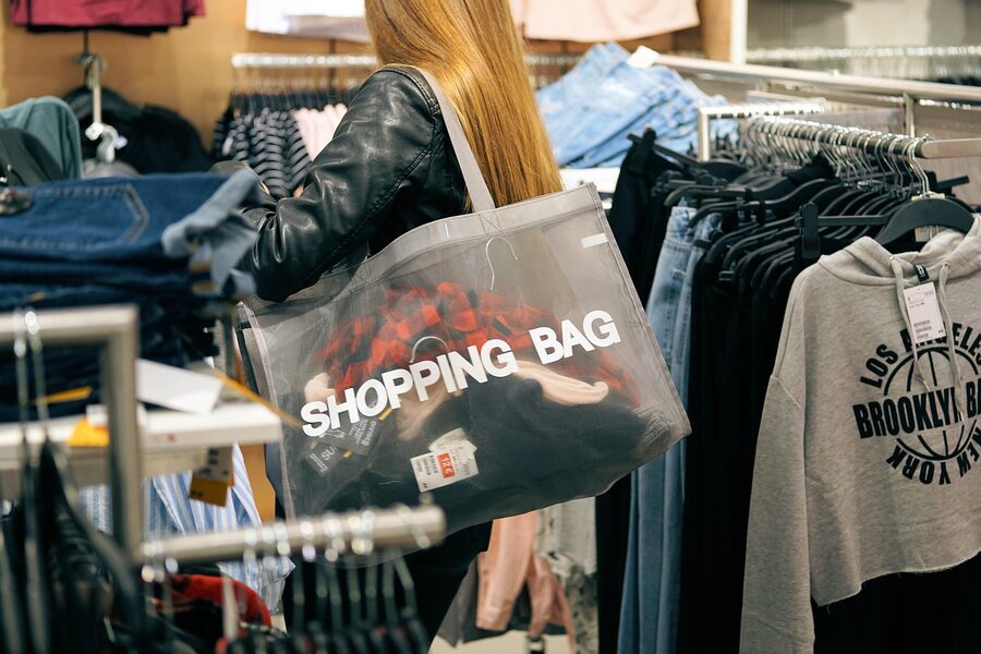 Woman with shopping bag in Italian fashion outlet