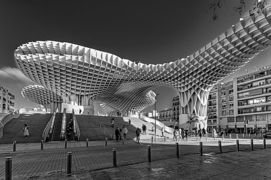 People walking on the rooftop of Setas de Sevilla in black and white