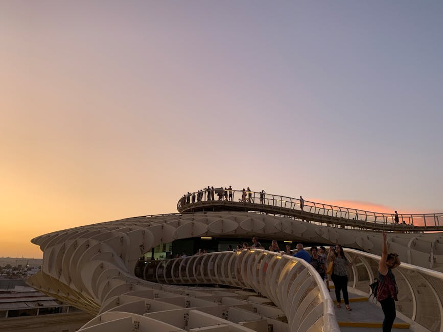 People walking the Setas de Sevilla walkway at sunset