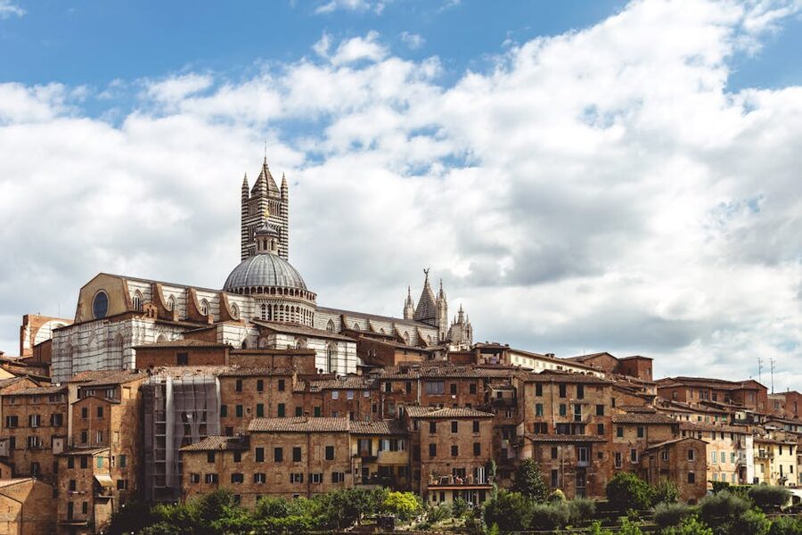 Siena cityscape with the cathedral rising above red-tiled roofs