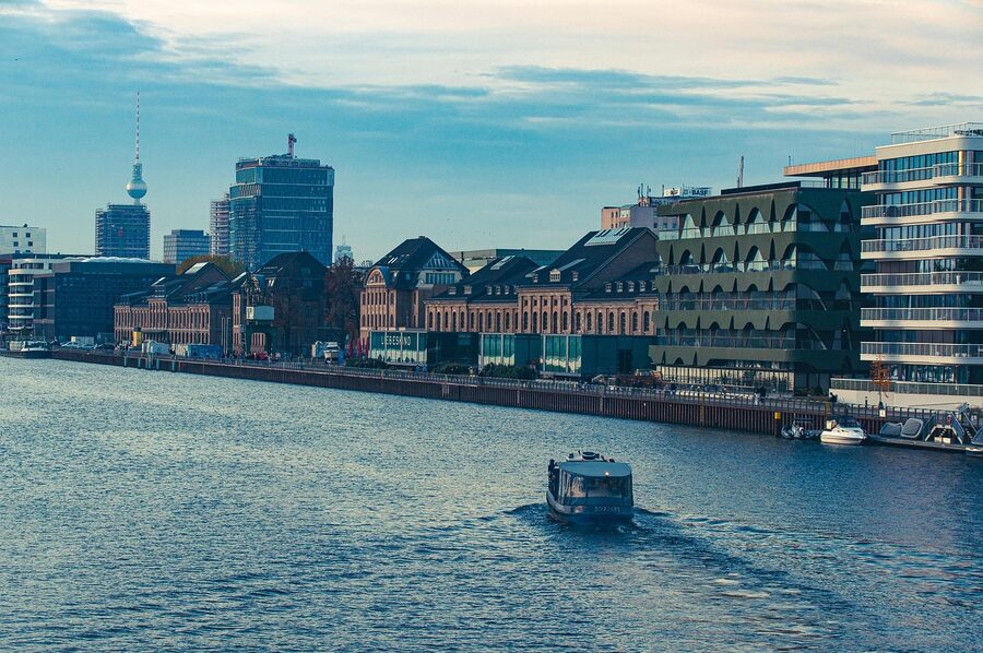 Boat on the Spree River Berlin with riverside buildings and urban scene