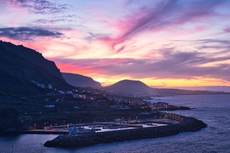 Sunset over a Tenerife harbour with mountains in the background