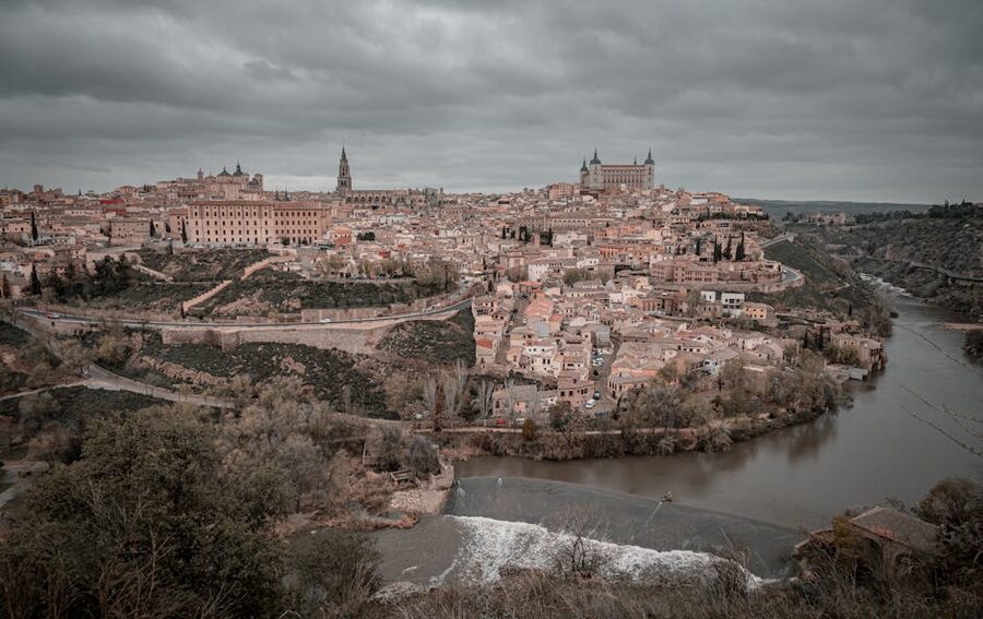 The medieval town of Toledo above a bend of the Tagus river, with old bridges and stone walls