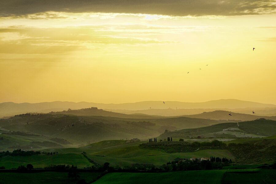 Tuscan hills at sunset wreathed in fog