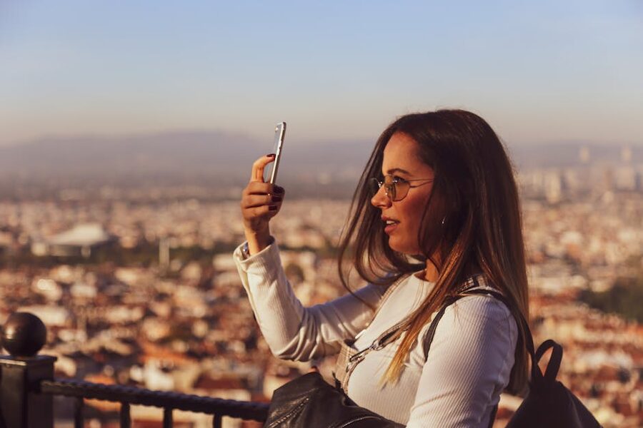 Visitor with cityscape selfie similar to post-museum content from the Upside Down Museum Amsterdam