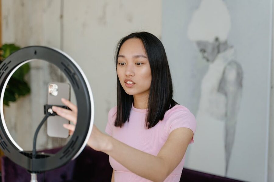 Content creator with ring light recording at a venue similar to the Upside Down Museum Amsterdam