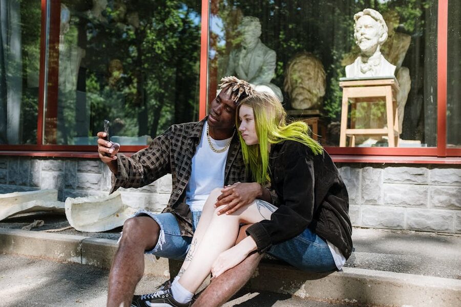 Couple taking a selfie outside a museum entrance similar to the Upside Down Museum Amsterdam