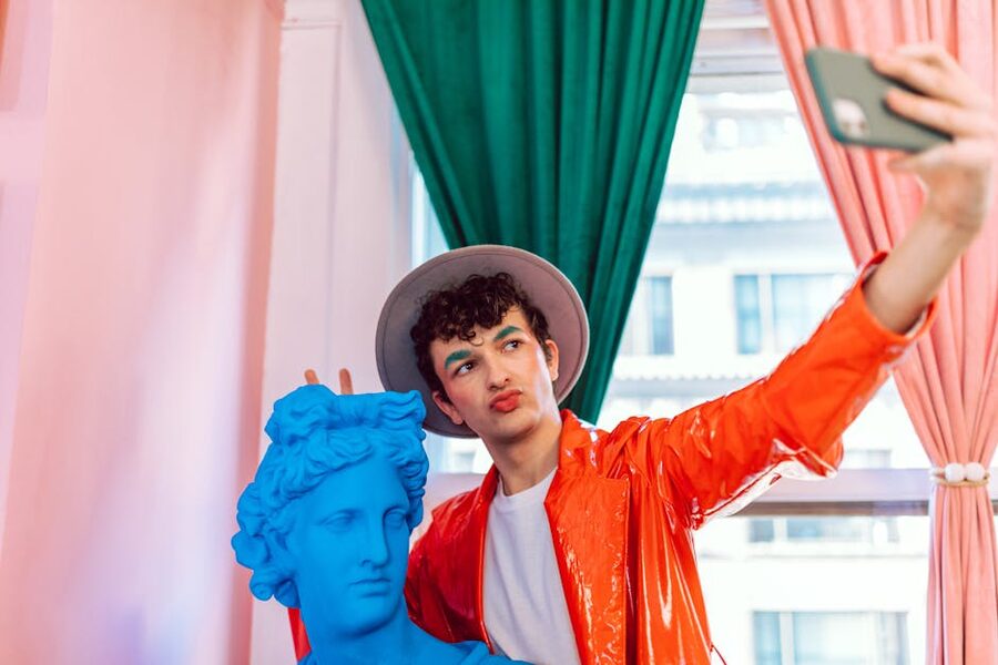 Visitor taking a selfie with a colorful statue inside an Instagram-friendly venue