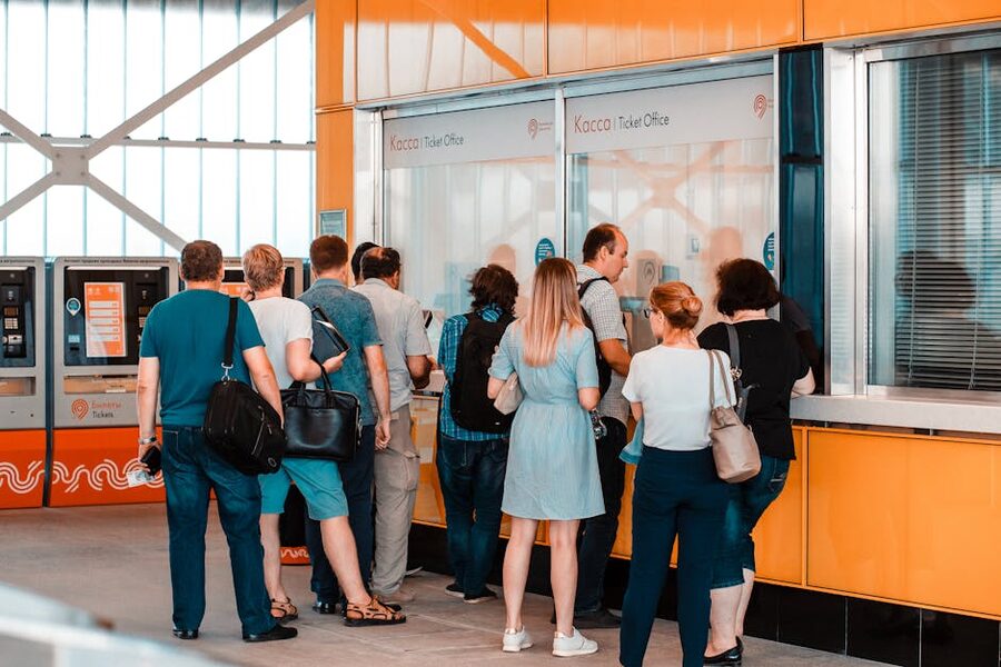 People at ticket booth comparable to the Upside Down Museum Amsterdam entrance