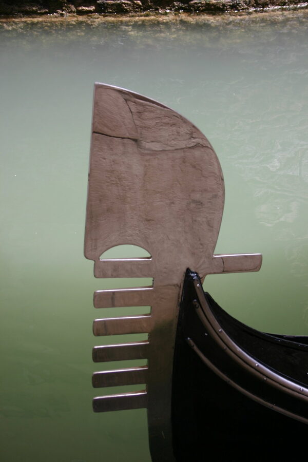 Close-up of the silver ferro di prua at the bow of a Venetian gondola