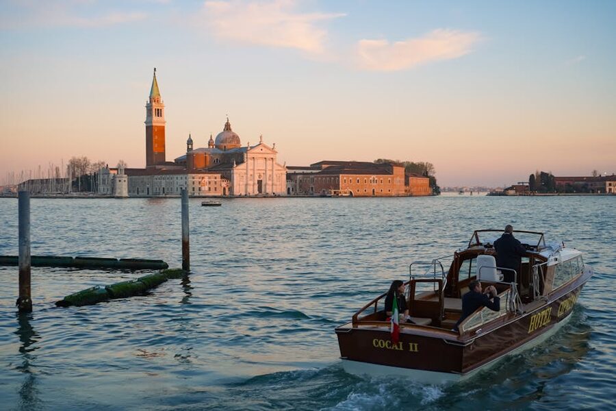 Venice lagoon at sunset with a passenger boat in the foreground
