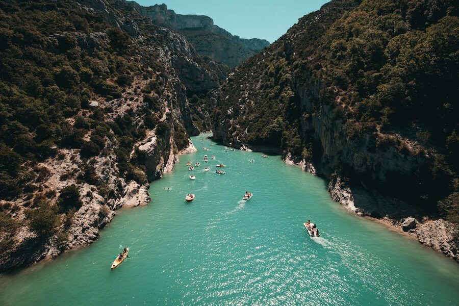 Kayakers on the Verdon River with canyon walls on either side