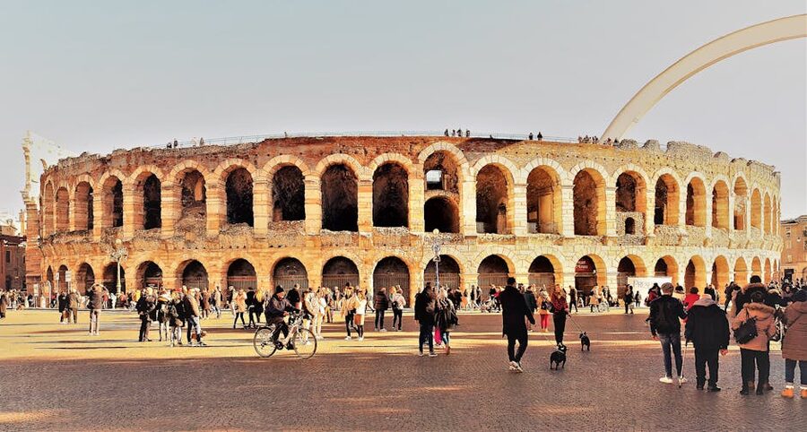 Tourists inside the Verona Arena looking at the seating tiers