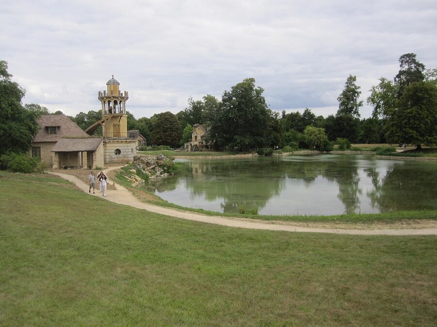 Hameau de la Reine in summer with thatched cottages and lake