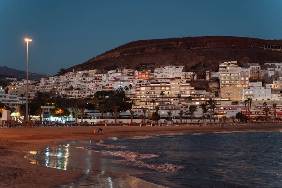 Los Cristianos beach and buildings at evening