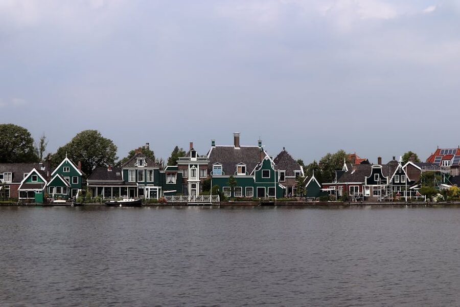 Dutch green houses reflected in the Zaan river