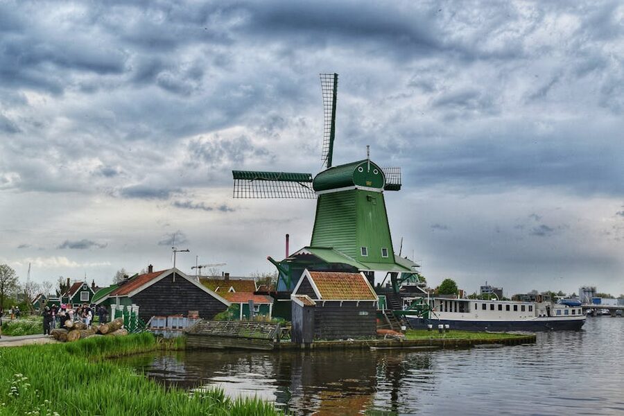 Green wooden windmill at Zaanse Schans on an overcast morning