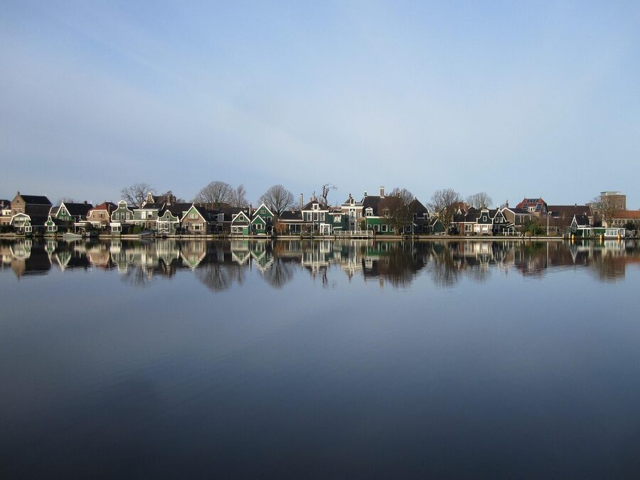 Zaanse Schans mills against blue sky with clogs in foreground