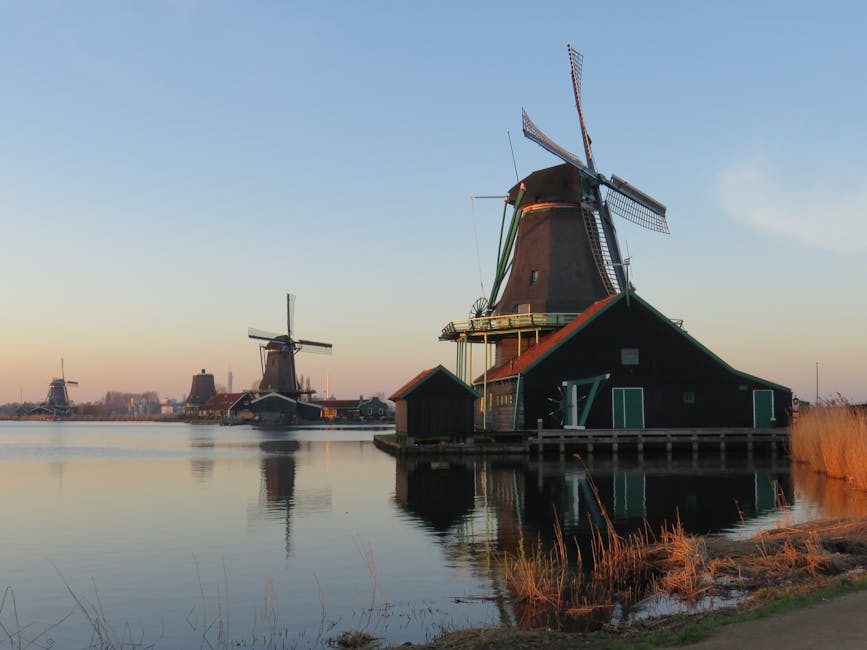 Zaanse Schans windmills reflected on the Zaan river at twilight